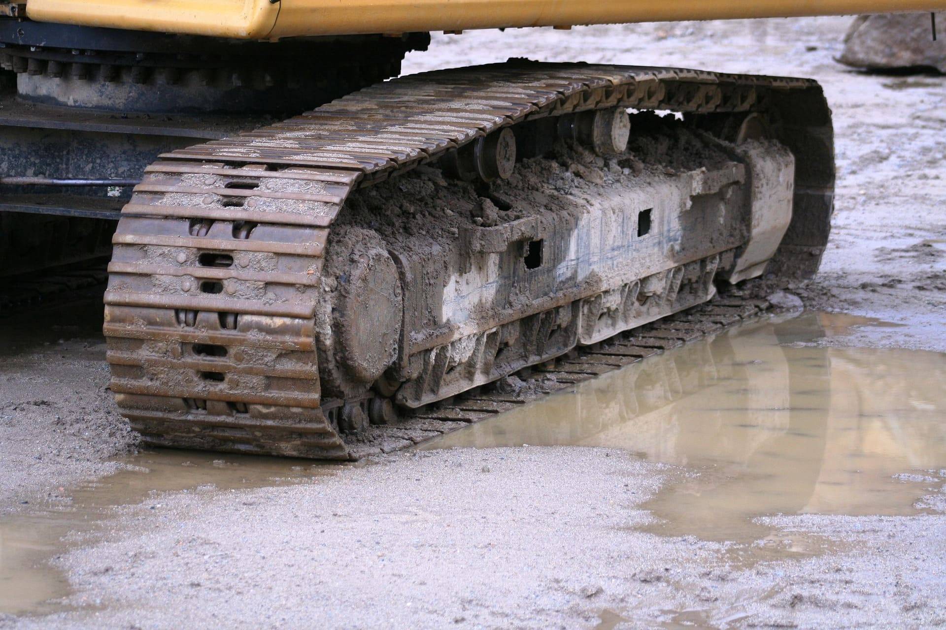 Excavator tracks in a wet ore processing area